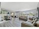Spacious living room with a fireplace, large windows for natural light, and neutral-toned furnishings at 622 Avenue D Se, Winter Haven, FL 33880