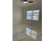 A bright, airy bedroom with a large window and modern tile flooring at 6366 Forecastle Ct, Orlando, FL 32807