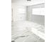 Bright bedroom with modern white and gold marble-patterned tile flooring and natural light at 6366 Forecastle Ct, Orlando, FL 32807