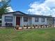 Charming single-story home with a well-maintained lawn and a bright red front door at 6366 Forecastle Ct, Orlando, FL 32807