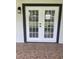 Exterior double French doors with black trim providing access to a patio at 6366 Forecastle Ct, Orlando, FL 32807
