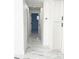 Bright white hallway with modern tile flooring and recessed lighting at 6366 Forecastle Ct, Orlando, FL 32807