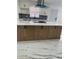 Kitchen island with ample storage, stone countertop, and stainless steel range hood at 6366 Forecastle Ct, Orlando, FL 32807