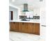 Open kitchen with stainless appliances, contrasting backsplash, and large island at 6366 Forecastle Ct, Orlando, FL 32807