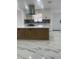 Open kitchen with stainless appliances, contrasting backsplash, and large island at 6366 Forecastle Ct, Orlando, FL 32807