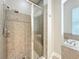 Bathroom featuring a shower with glass door and a tiled shower seat at 6971 Tettenhall Ln, Windermere, FL 34786