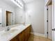 Bathroom featuring double sinks, a large mirror, tiled floors, and wooden cabinets at 6971 Tettenhall Ln, Windermere, FL 34786