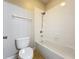 Bathroom featuring a toilet, bathtub, shower head, and tiled walls at 6971 Tettenhall Ln, Windermere, FL 34786