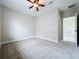 Neutral bedroom with plush carpet, ceiling fan and a doorway to another room at 6971 Tettenhall Ln, Windermere, FL 34786