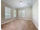 A spacious bedroom with neutral walls, large windows, and carpet flooring, bathed in natural light at 6971 Tettenhall Ln, Windermere, FL 34786