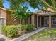 Landscaped backyard with a private screened-in patio at 6971 Tettenhall Ln, Windermere, FL 34786