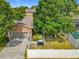 Charming home with a two-car garage, complemented by lush landscaping and a white picket fence at 6971 Tettenhall Ln, Windermere, FL 34786