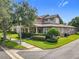 Charming home with a well-manicured lawn, mature trees, and inviting curb appeal on a sunny corner lot at 6971 Tettenhall Ln, Windermere, FL 34786