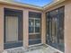Charming screened-in lanai with exterior door and rocky landscape at 6971 Tettenhall Ln, Windermere, FL 34786