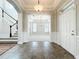Bright entryway boasting tile floors, an elegant chandelier, staircase and an open view to the living room at 6971 Tettenhall Ln, Windermere, FL 34786