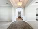 Inviting home foyer featuring neutral walls, a decorative light fixture, and ceramic tile transitioning to hardwood flooring at 6971 Tettenhall Ln, Windermere, FL 34786