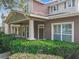 Welcoming home exterior showcasing a covered porch, detailed columns, and well-maintained green shrubbery at 6971 Tettenhall Ln, Windermere, FL 34786
