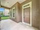 A welcoming front porch with classic features, stucco columns, a neutral color scheme, and easy access to the entrance at 6971 Tettenhall Ln, Windermere, FL 34786