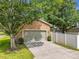 Detached two-car garage with mature landscaping at 6971 Tettenhall Ln, Windermere, FL 34786