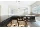 Modern kitchen features stainless steel sink and black granite countertops, plus easy flow into the living room at 6971 Tettenhall Ln, Windermere, FL 34786
