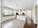 Bright kitchen features white cabinets, black countertops and appliances, and tile flooring at 6971 Tettenhall Ln, Windermere, FL 34786