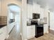 Kitchen featuring black appliances, white cabinetry, and tile flooring at 6971 Tettenhall Ln, Windermere, FL 34786
