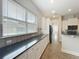 Bright kitchen view with long countertops, large windows, and tile backsplash at 6971 Tettenhall Ln, Windermere, FL 34786