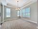 Bright living room with large windows and elegant chandelier at 6971 Tettenhall Ln, Windermere, FL 34786