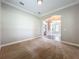 Spacious carpeted living room with archway leading to other rooms in the home at 6971 Tettenhall Ln, Windermere, FL 34786