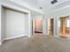 Spacious primary bedroom featuring carpet, access to closet, and ensuite bathroom at 6971 Tettenhall Ln, Windermere, FL 34786