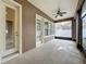 Covered patio with ceiling fan and neutral colors at 6971 Tettenhall Ln, Windermere, FL 34786