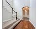 Elegant staircase with carpeted steps and wood floors in the entryway at 6971 Tettenhall Ln, Windermere, FL 34786