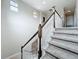 Staircase with carpeted steps and a dark wood banister at 6971 Tettenhall Ln, Windermere, FL 34786