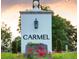 Elegant community entrance sign with lush landscaping and a welcoming atmosphere at 7011 Via Carmel Way, Orlando, FL 32819