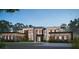 Striking modern home featuring clean lines, expansive windows, and a thoughtfully landscaped yard at 7011 Via Carmel Way, Orlando, FL 32819