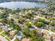 Neighborhood aerial shows homes with private pools near a serene lake at 7022 Talbot Dr, Orlando, FL 32819