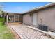 Home exterior featuring brick patio, screened lanai, and AC unit at 7022 Talbot Dr, Orlando, FL 32819