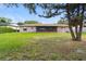 Expansive backyard showing lush lawn, screened patio, and the home's exterior at 7022 Talbot Dr, Orlando, FL 32819