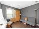 A bedroom has hardwood floors, wooden accents, and neutral colors, offering a cozy atmosphere at 7022 Talbot Dr, Orlando, FL 32819