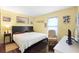 Well-lit bedroom with a wooden floor, queen-size bed, chair and a window with blinds at 7022 Talbot Dr, Orlando, FL 32819
