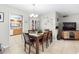 Well-lit dining area with a wooden table, seating for six, and decorative accents on the wall at 7022 Talbot Dr, Orlando, FL 32819