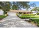 Inviting single-Gathering home with a two-car garage and a spacious driveway, surrounded by manicured landscaping at 7022 Talbot Dr, Orlando, FL 32819
