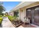 Close-up of the front door, showcasing the wood design, exterior lighting, and attractive landscaping at 7022 Talbot Dr, Orlando, FL 32819