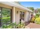 Welcoming front entrance with a decorative wooden door, stylish exterior lighting, and lush landscaping at 7022 Talbot Dr, Orlando, FL 32819