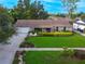 Well-maintained front yard of single story home with manicured lawn and trimmed landscaping at 7022 Talbot Dr, Orlando, FL 32819