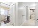 Hallway showcases a bathroom entrance with marble countertops, a shower-tub combo, and tile flooring at 7022 Talbot Dr, Orlando, FL 32819
