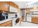 A well-equipped kitchen featuring stainless steel appliances and wooden cabinets offers functionality and style at 7022 Talbot Dr, Orlando, FL 32819