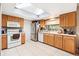 A sunlit kitchen showcases wooden cabinets, stainless steel appliances, and a skylight for natural light at 7022 Talbot Dr, Orlando, FL 32819