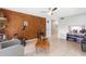 Living room with wood-paneled wall, tile floors, and a cozy ambiance offers a comfortable retreat at 7022 Talbot Dr, Orlando, FL 32819