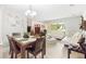 Open-concept living and dining area featuring tile flooring, a dining set, and comfortable seating at 7022 Talbot Dr, Orlando, FL 32819